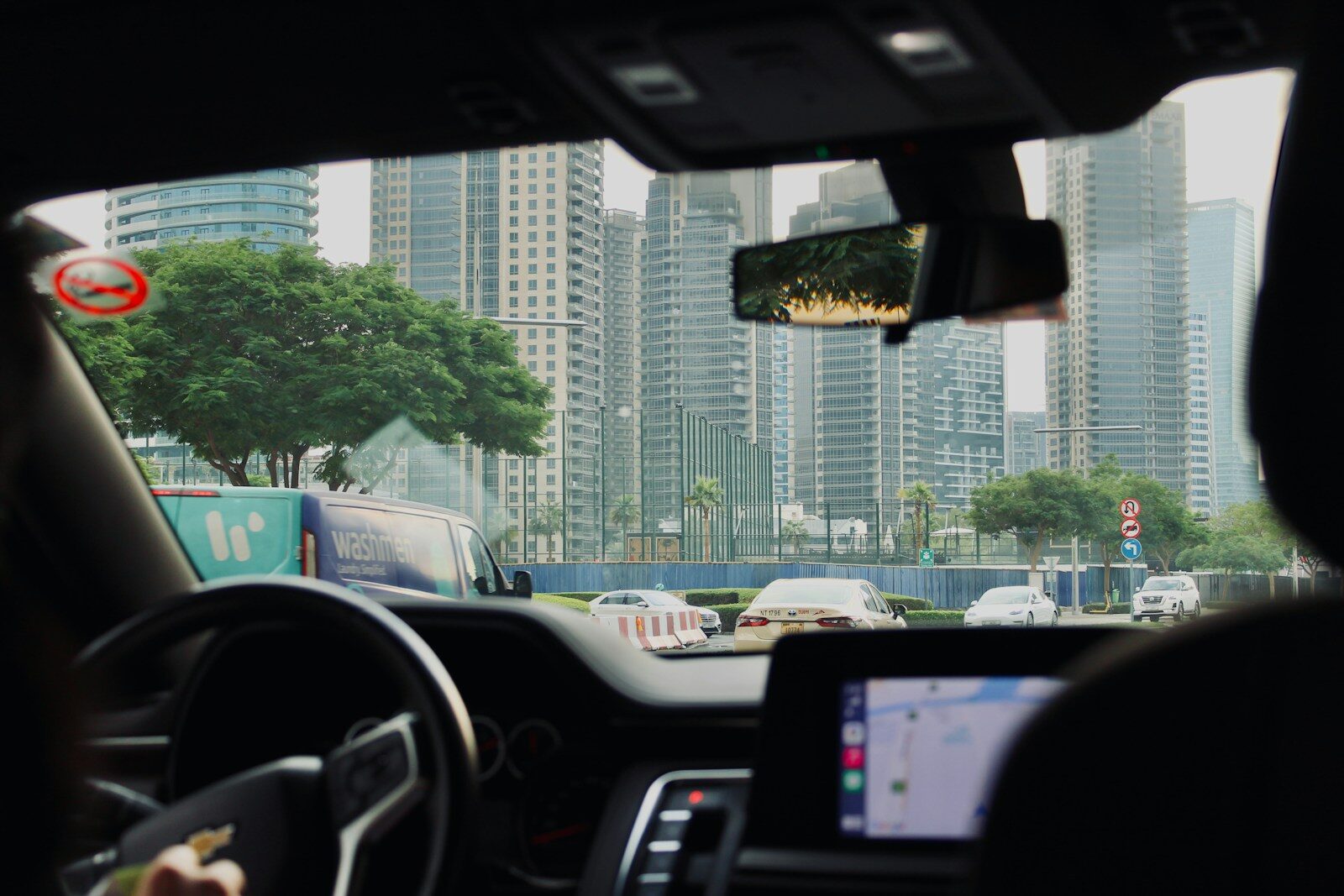 View from car driving through a modern city.